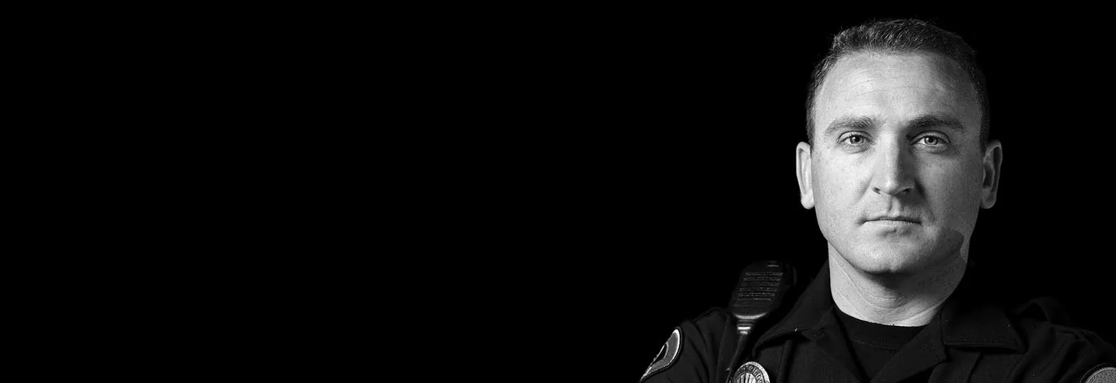 Serious police officer in uniform looking forward — representing GEKLAW’s unwavering support for injured law enforcement officers and first responders in California.